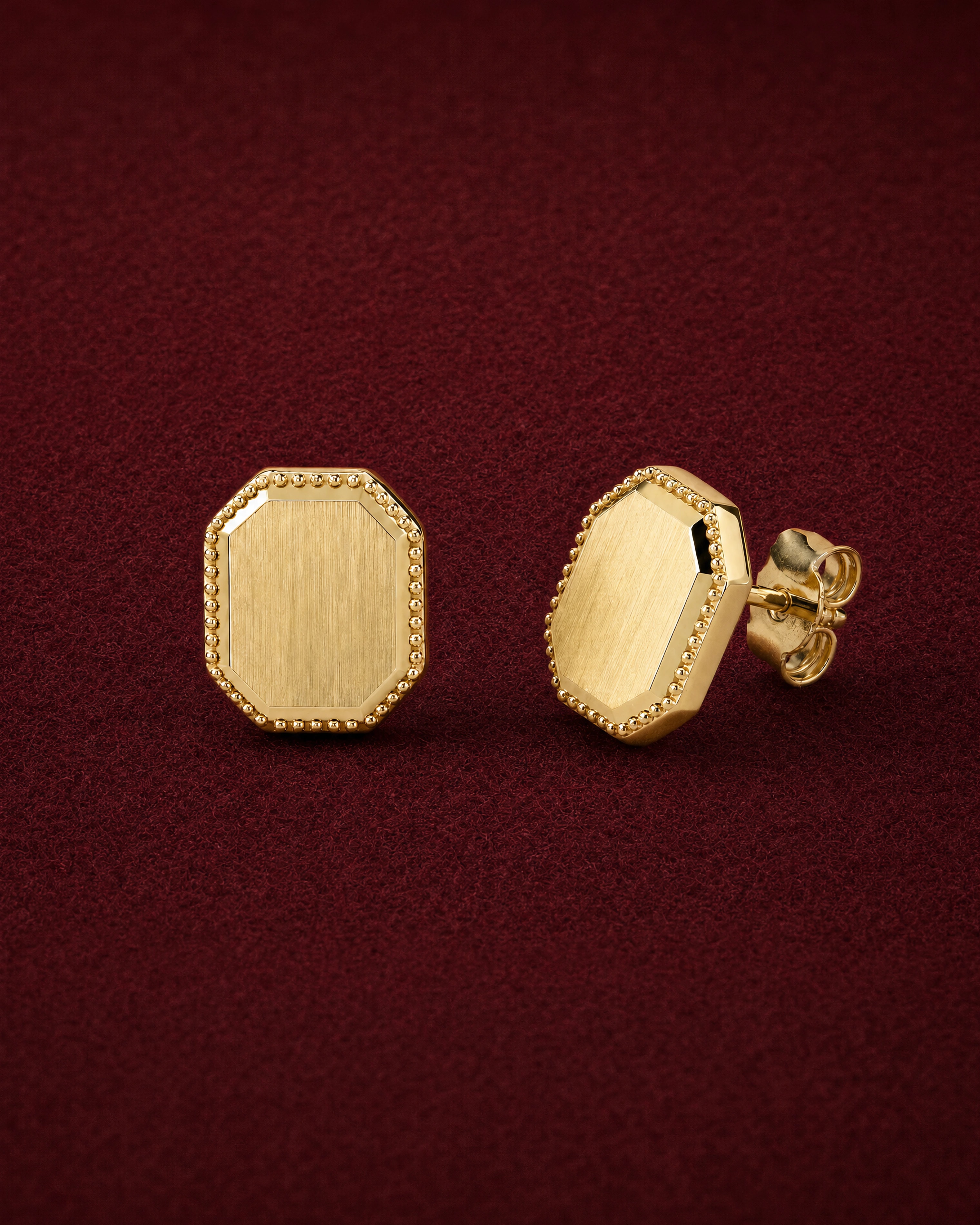 Pebble Studs: small domed octagon studs in 18k gold with granule edges, on garnet jeweler's felt