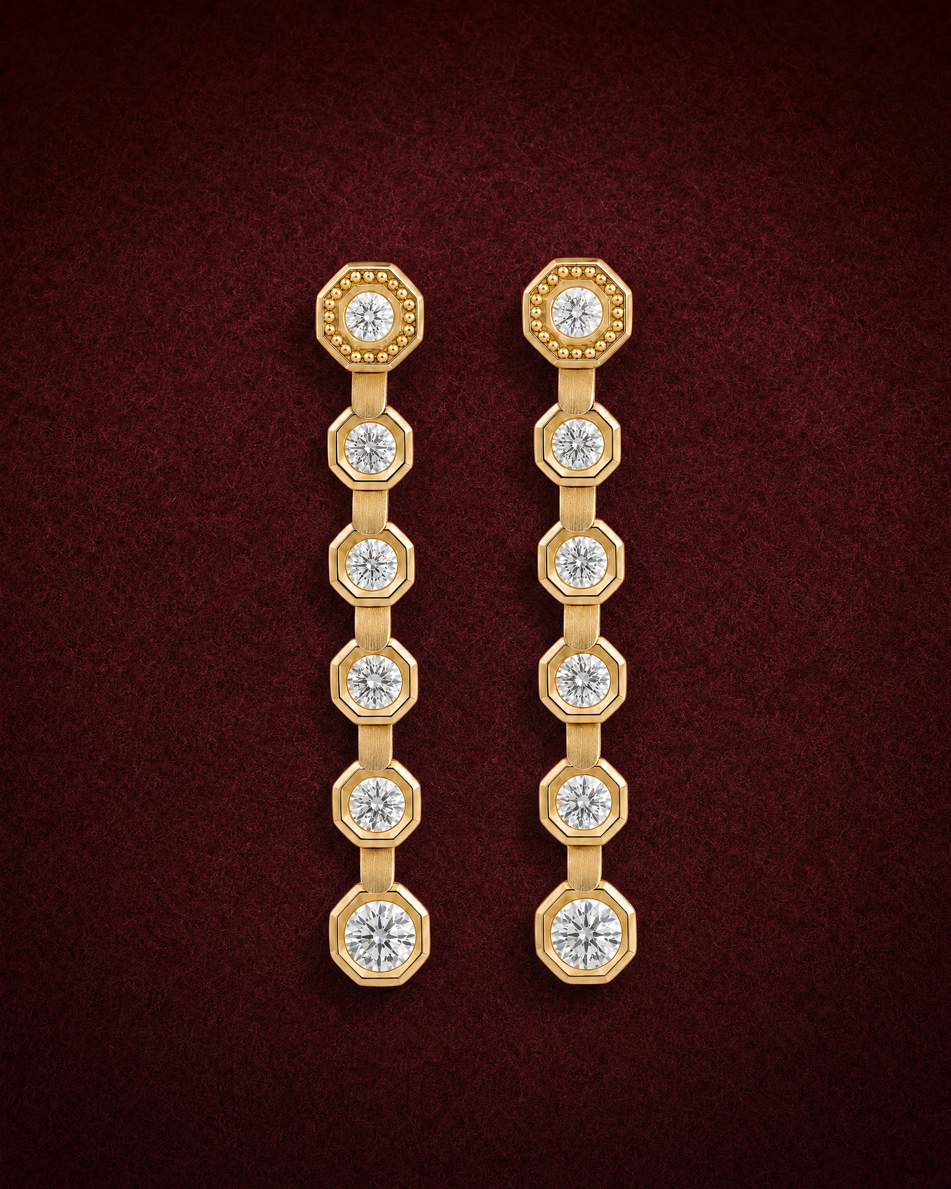 Diamond Line Drops with six diamonds in octagonal 18k gold bezels, on garnet jeweler's felt